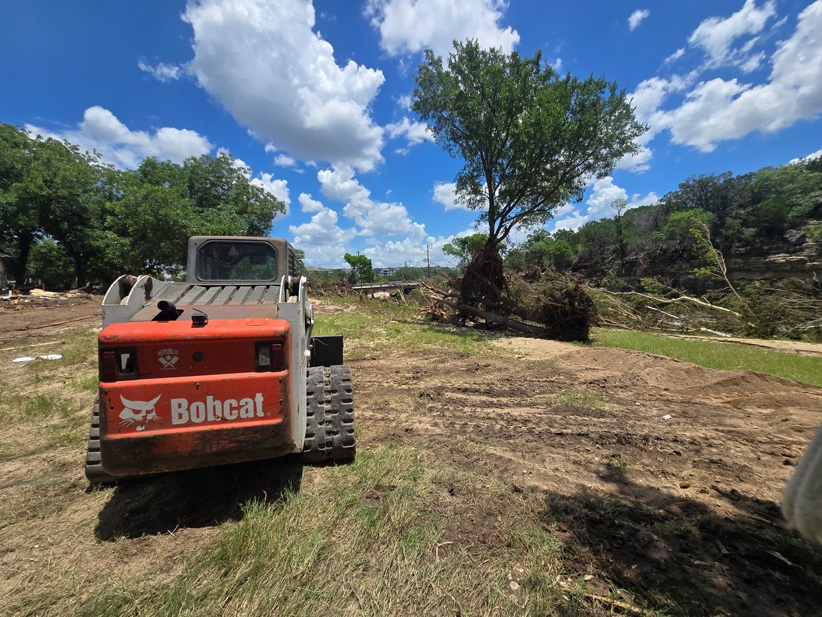 Bobcat clearing debris